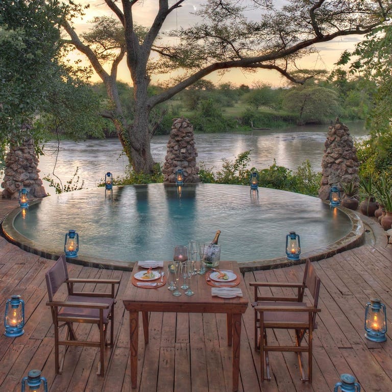 Dining-at-the-swimming-pool-at-andbeyond-grumeti-on-a-luxury-tanzania-safari