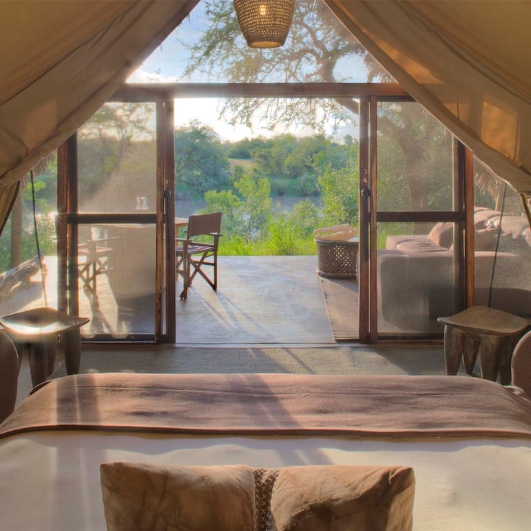 suite-interior-with-river-views-at-grumeti-serengeti-tented-camp-on-a-tanzania-luxury-safari-inspired-by-great-migration-1